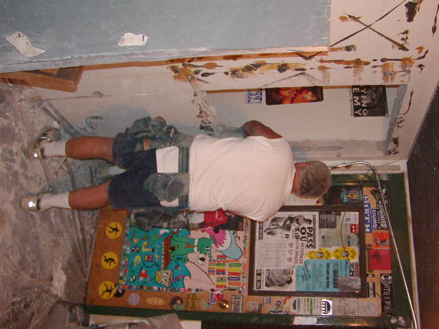 Carpentry contractor cutting the cement wall where the new doorway will lead into Studio C. Picture taken from in the old production room, notice the old production room door